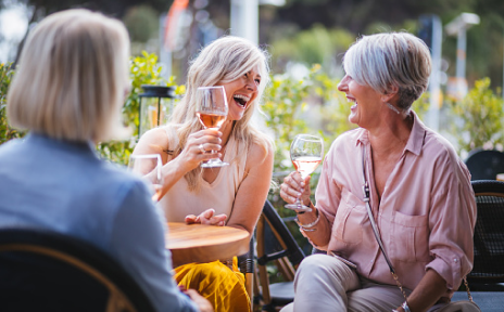 Mature friends laughing at a lunch