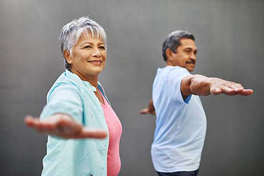 Mature couple doing yoga without the fear of falling.